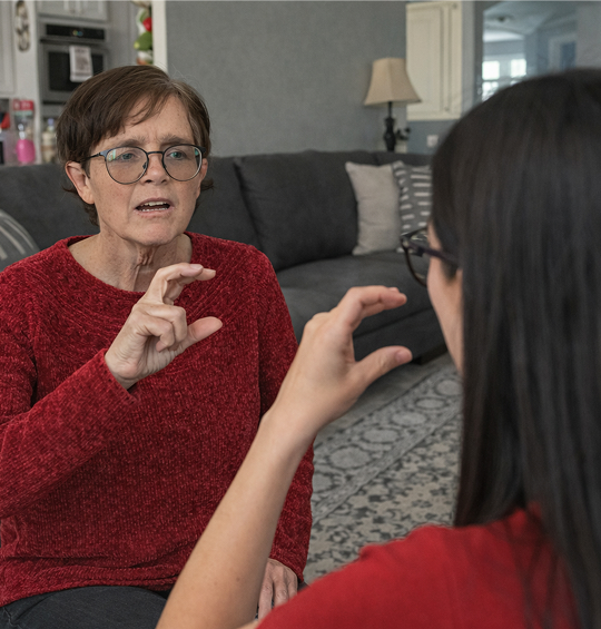 Practicing ASL in a cozy living room
